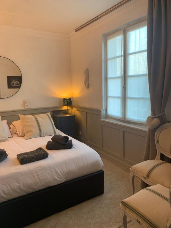 Triac-LautraitBelle Chambre的一间卧室设有一张床、一个窗口和一把椅子