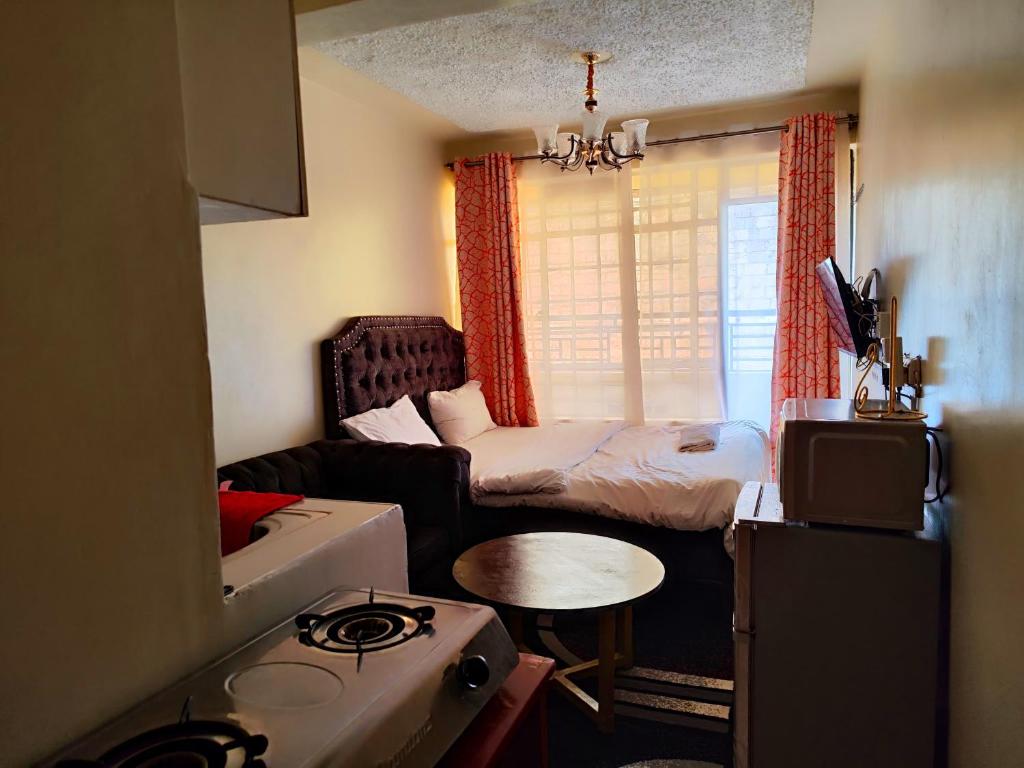 KikuyuTravelers staycation - 15 Mins to Westlands的小房间设有床和沙发