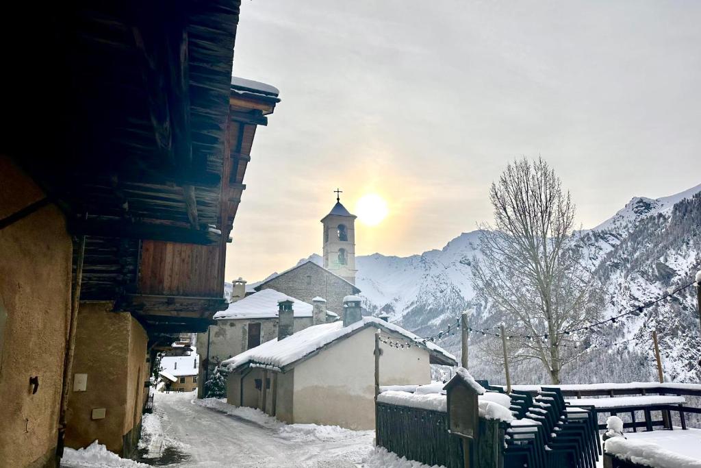 圣韦朗CASA-La Fuste center St-Véran foot of the slopes 6p的一座小镇,有教堂和一条雪覆盖的街道