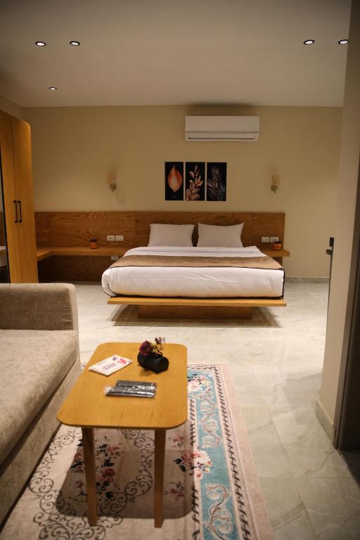 开罗Regal view Aparthotel的一间卧室配有一张床和一张沙发咖啡桌