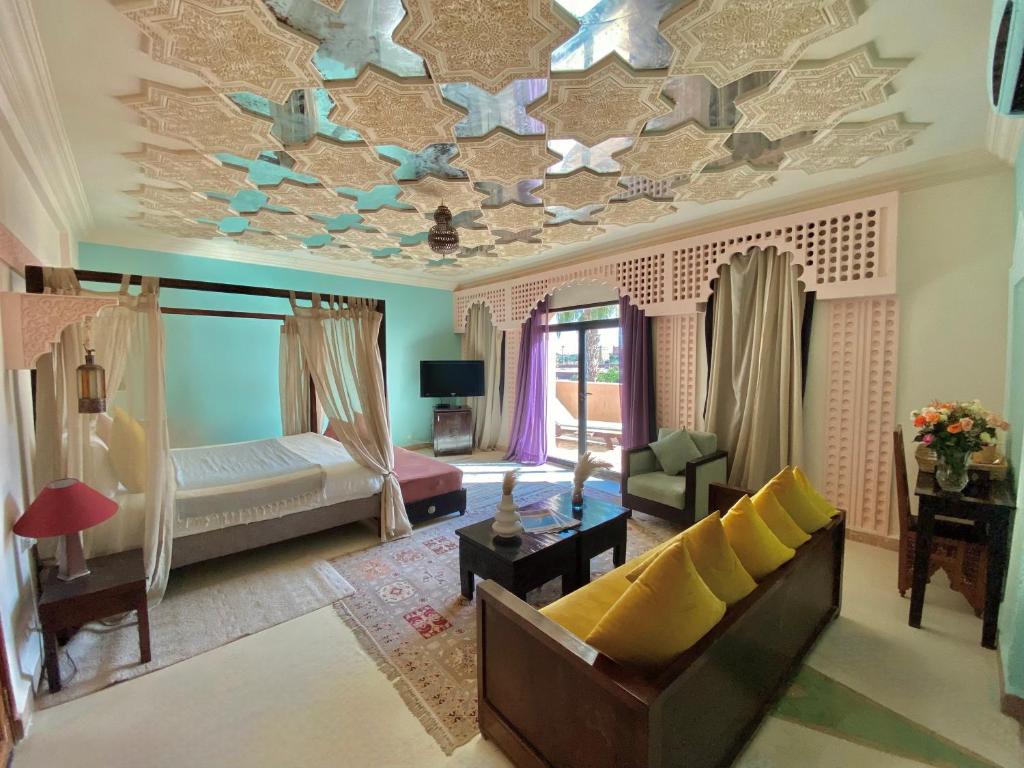 马拉喀什La Villa Des Golfs & PinkCactus的客厅设有装饰有蝴蝶的天花板