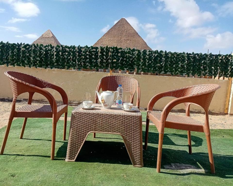 开罗ElBayt motel的两张椅子和一张桌子,上面放着茶具