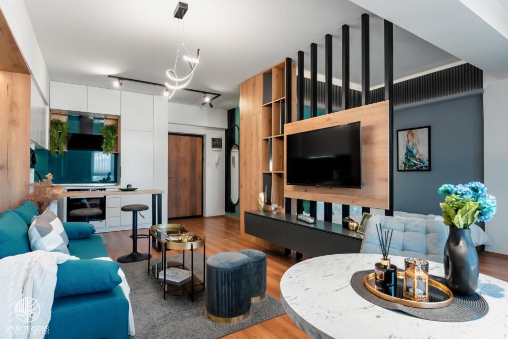 比托拉Four Seasons Luxury Apartment的客厅配有蓝色的沙发和桌子
