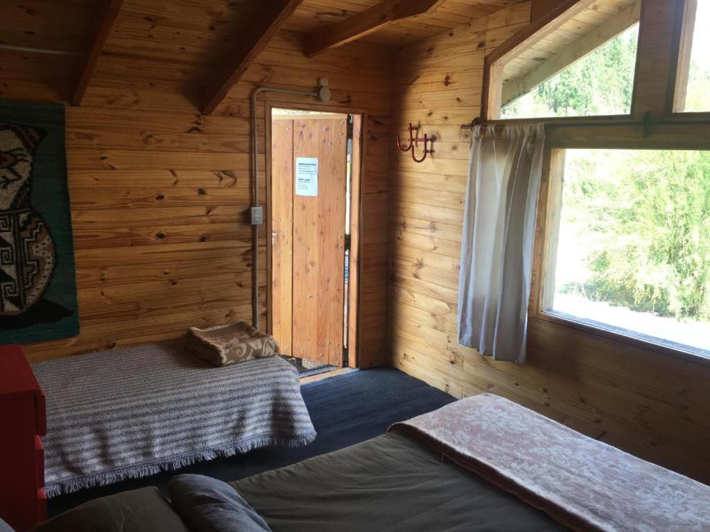 埃普延Carelhue的小木屋内的一个房间,配有床和窗户