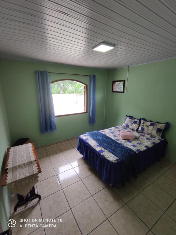 马卡埃Casa Muro Alto-Sana Rj的一间带床的卧室,位于带窗户的房间内