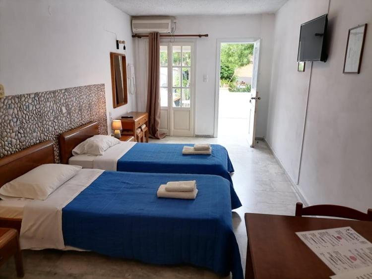 卡利诺岛Katerina Apartments的酒店客房,配有两张带毛巾的床