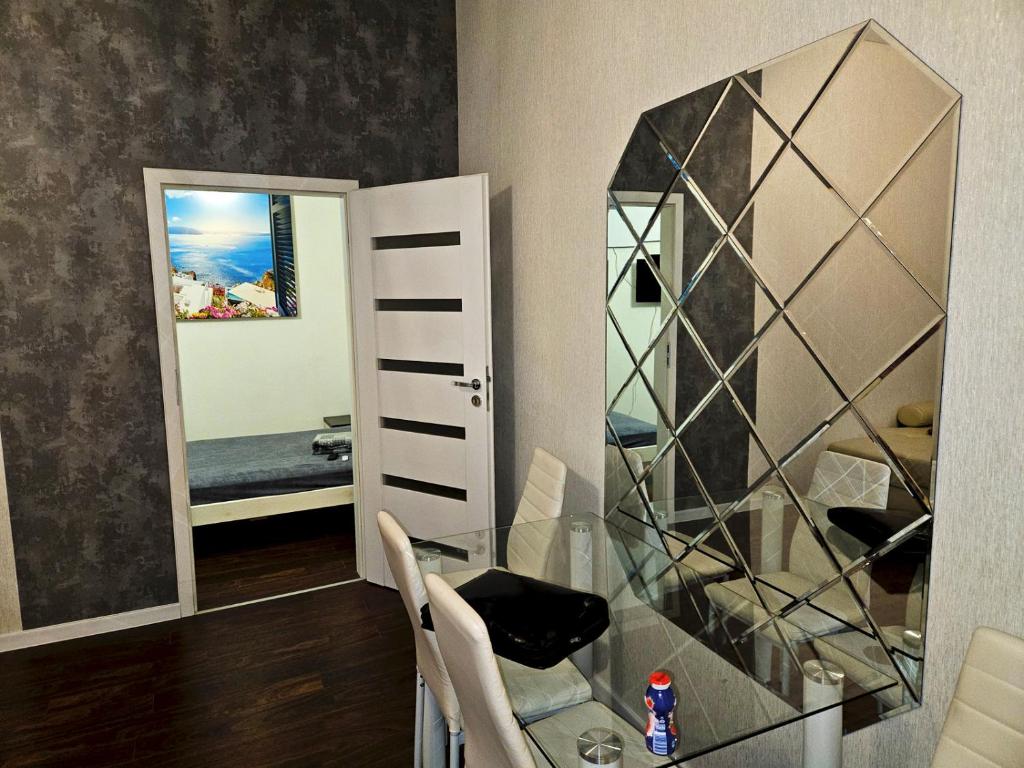 比托姆Apartament Moniuszki Starówka Bytom 40m2的一间设有玻璃桌和镜子的用餐室