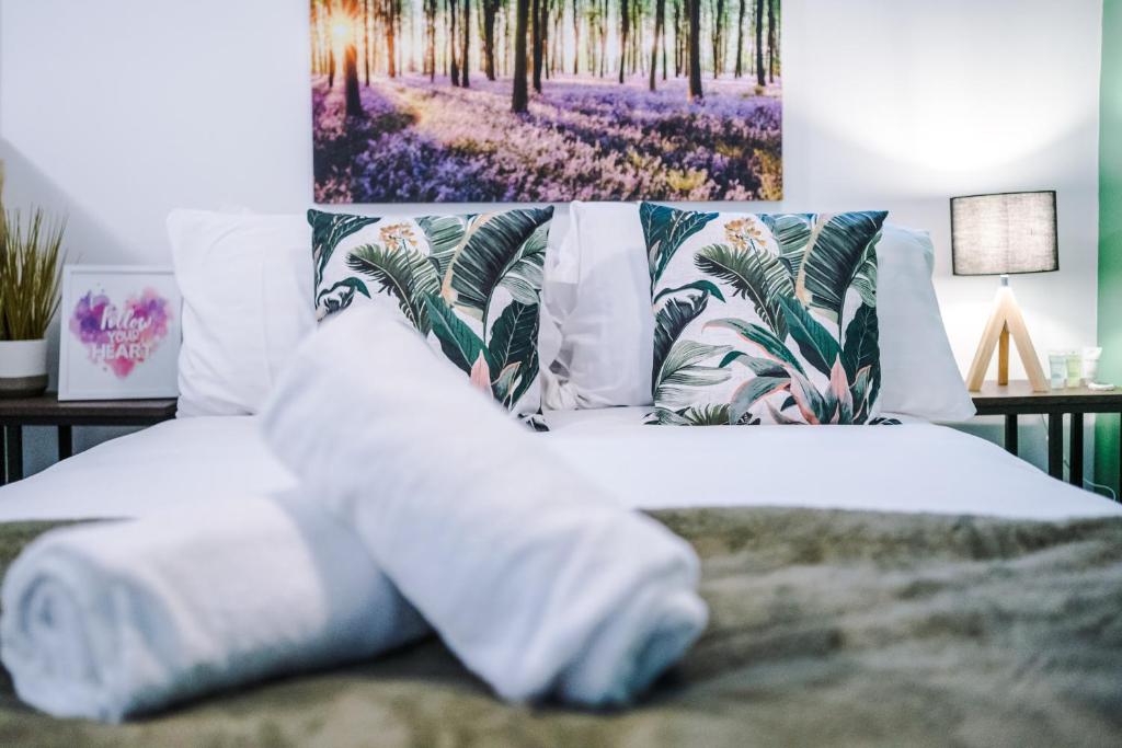 利物浦Charming abode near city centre/free parking的一间卧室配有白色床单和鲜花。