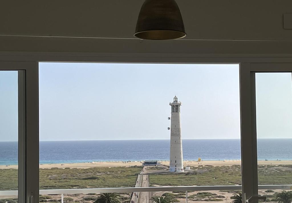 莫罗德哈布雷Blue Ocean Morro Jable的从带窗户的房间内可欣赏到灯塔的景色