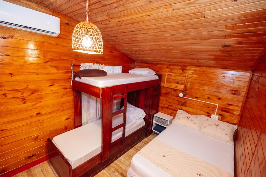 恩卡纳西翁Cabin Renty Beach的小木屋内带两张床的房间