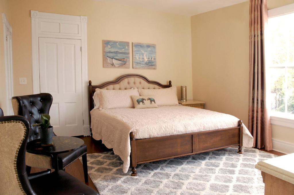 圣奥古斯丁MayLi Place Luxury King Suite Downtown St Augustine的卧室配有床、椅子和窗户。