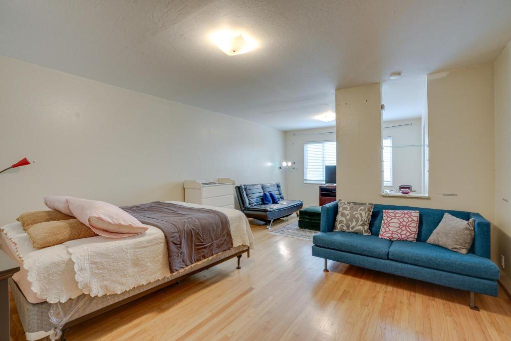 奥克兰Cozy Oakland Studio Rental, 13 Mi to San Francisco的一间卧室配有一张床和一张蓝色的沙发