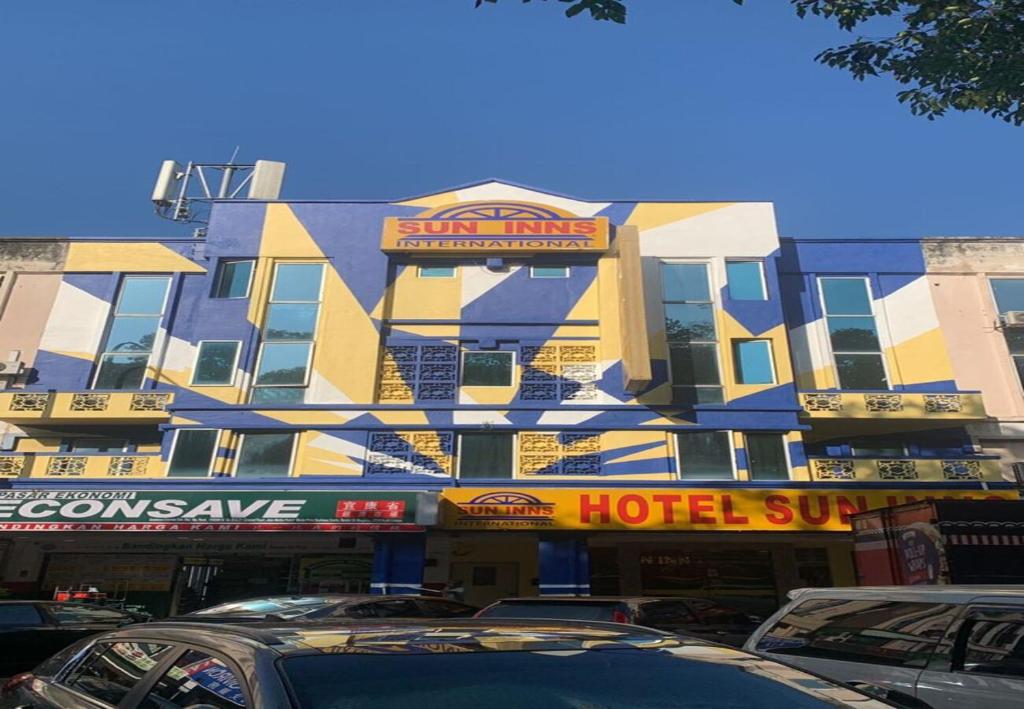 吉隆坡Sun Inns Hotel Kepong near Hospital Sungai Buloh的酒店大楼前面设有停车场