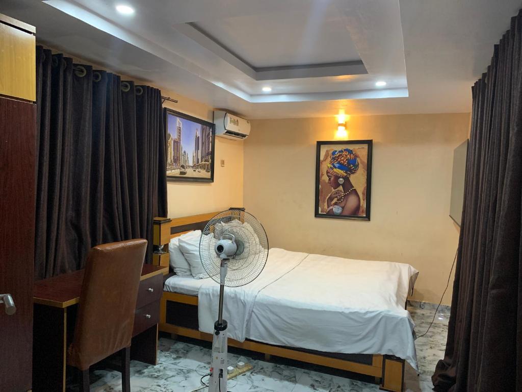 伊巴丹Umbrella properties - Eleyele Ibadan的客房设有带风扇的床铺。