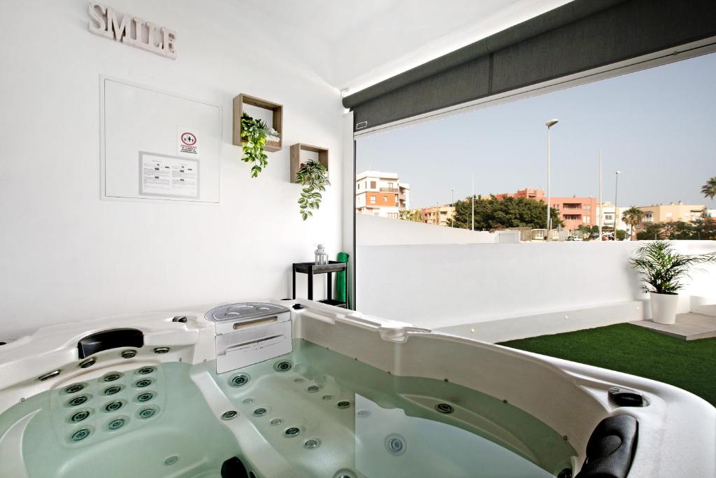 坎德拉里亚El Ramonal Vacacional的一间带大窗户和浴缸的浴室