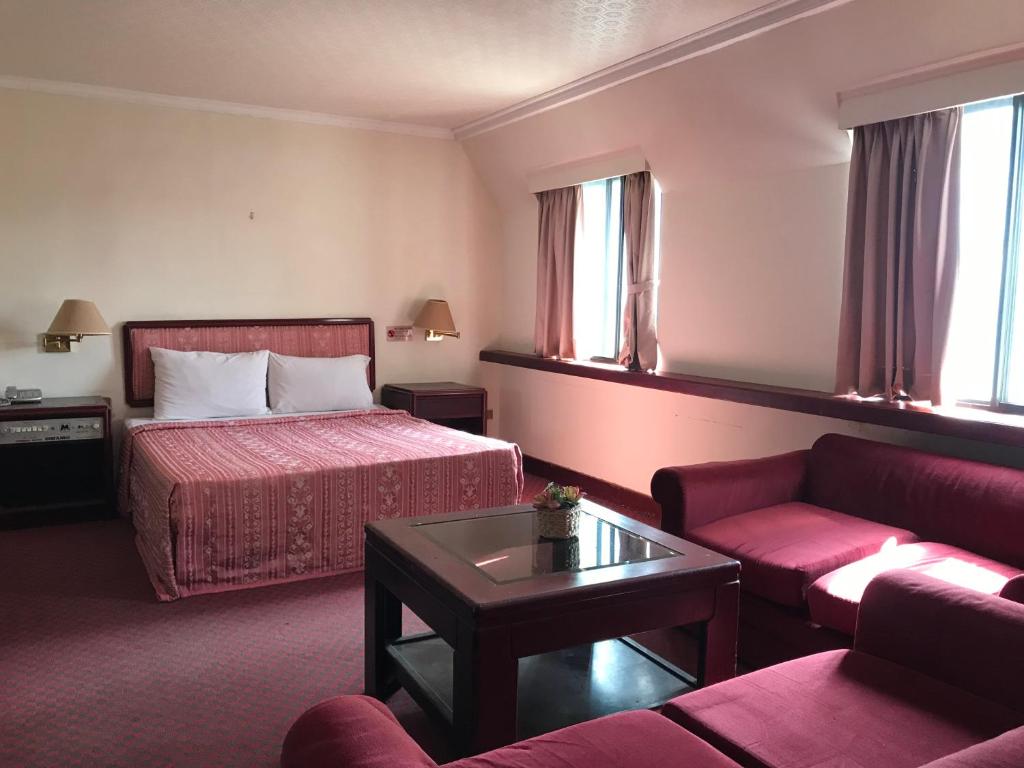 台中市Marshal Hotel Taichung名帥大飯店的酒店客房,配有床和沙发
