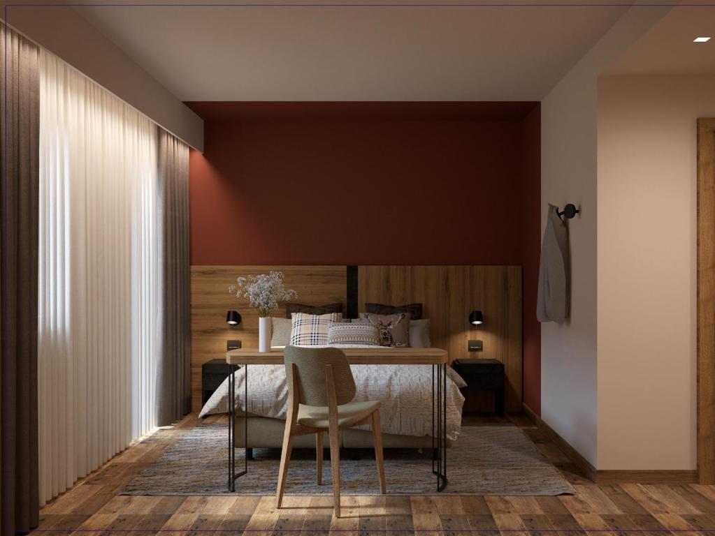 佛加里达Armon Greenblu Hotel & Wellness的卧室配有一张床和一张桌子及椅子