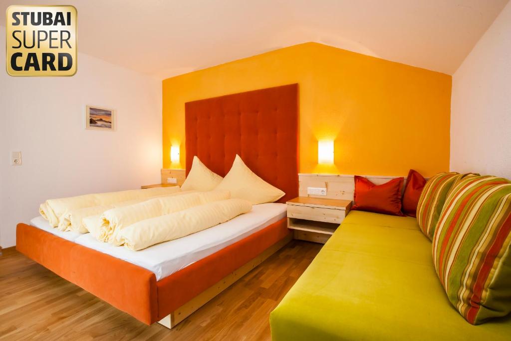 施图拜河谷新施蒂夫特艾尔皮娜努斯特宾馆的一间卧室设有一张大床和黄色的墙壁