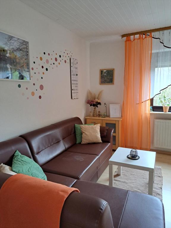 弗尔克林根Ferienwohnung Niklas的客厅配有棕色沙发和桌子