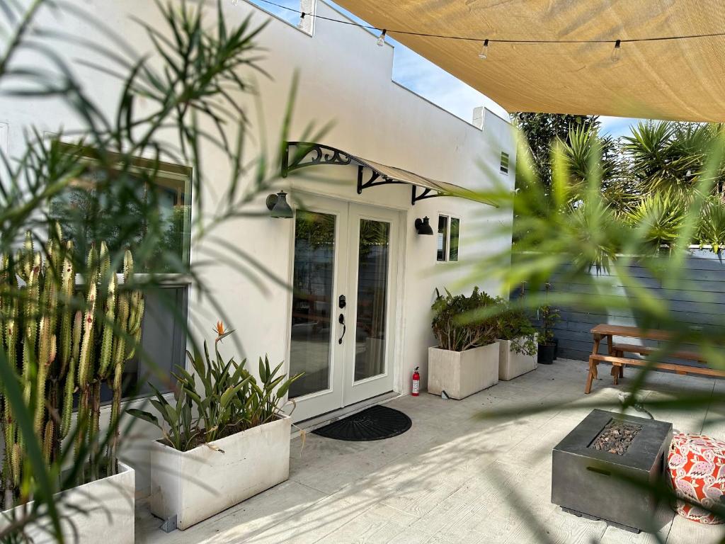 洛杉矶Resort Getaway in Private Garden Terrace Villa w Luxury Amenities的门前有盆栽的房屋