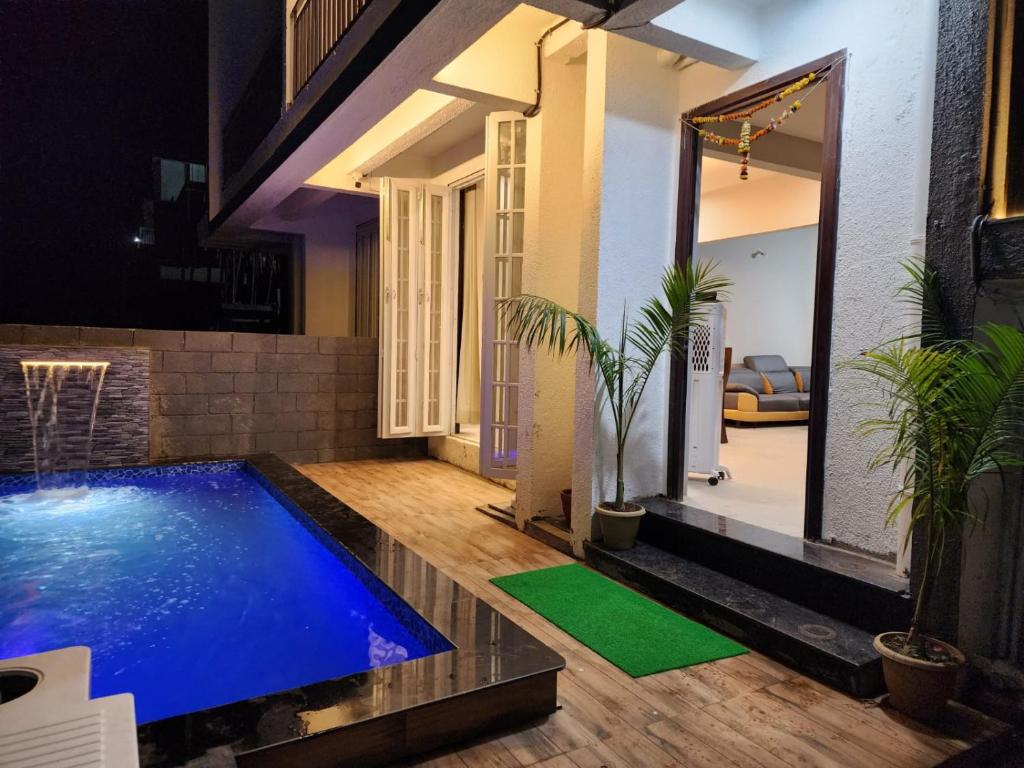 罗纳瓦拉Twilight Villa ll Swimming Pool ll AC ll BBQ ll 2BHK的庭院中间带游泳池的房子