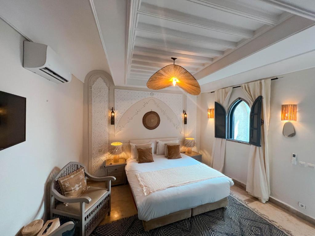 马拉喀什Riad Jonan & Spa的一间卧室配有一张床和一把椅子