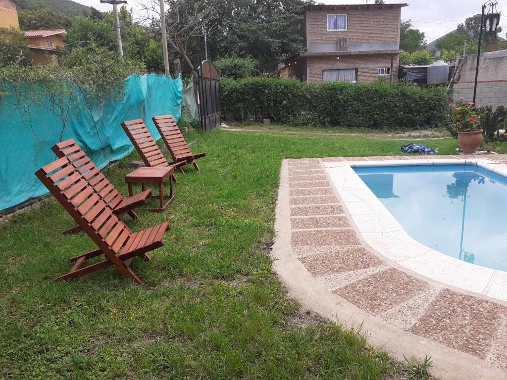 温基约CASONA DELVUELO的一组椅子坐在游泳池旁