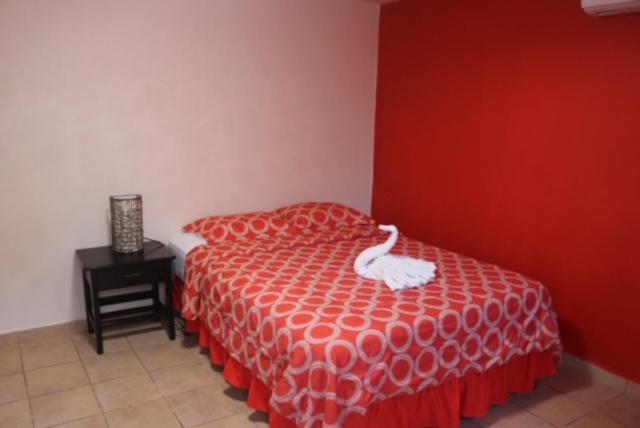拉斯塔布拉斯Uverito Sand Dollar B&B的一间卧室配有一张白色天鹅床