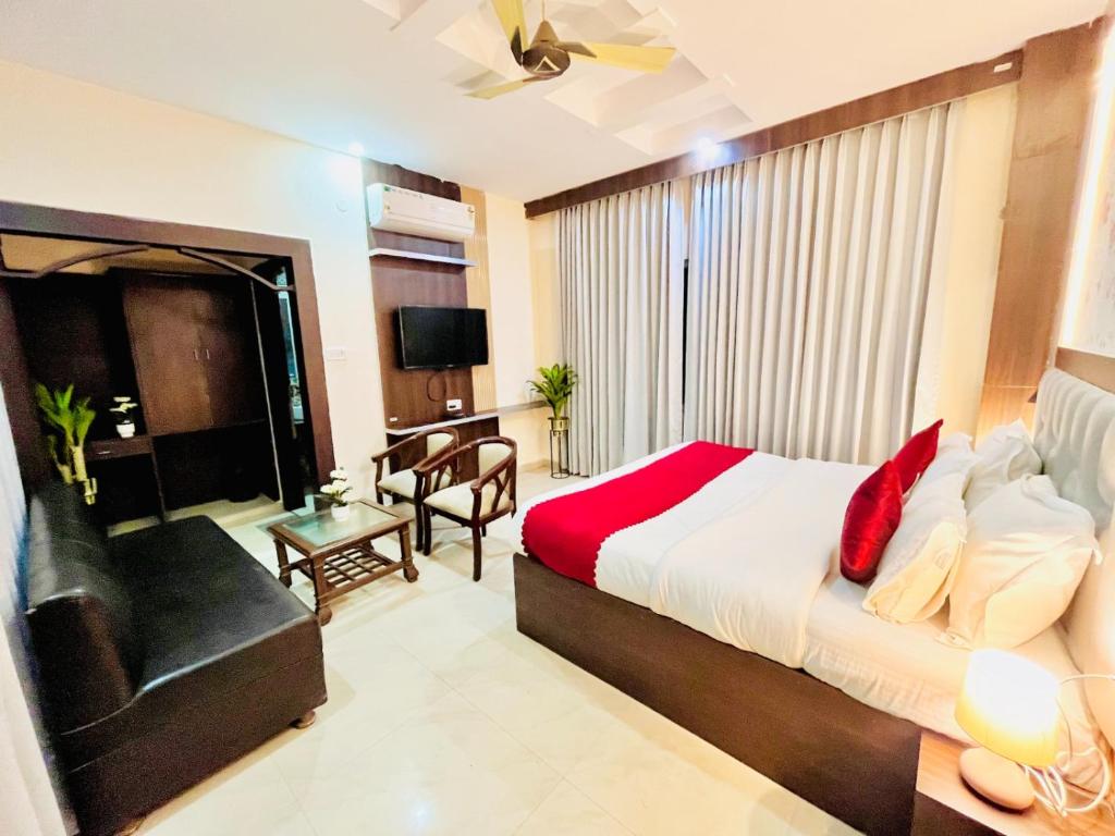哈里瓦Hotel Rama, Top Rated and Most Awarded Property In Haridwar的一间卧室配有一张床、一把椅子和一张沙发