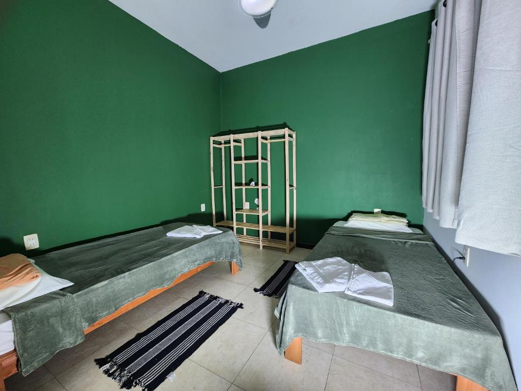 塞拉Refugio em costa bela Beach的绿墙客房的两张床