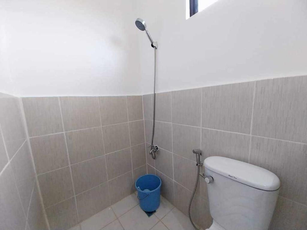 Lapu Lapu CityBungalow House-Olango Island的带淋浴的浴室,配有卫生间和水桶