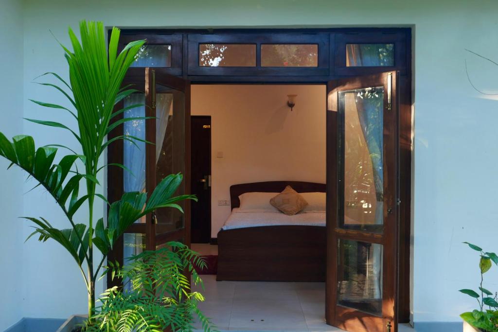 康提The Bliss Hostel Kandy的一间卧室,配有床和一些植物