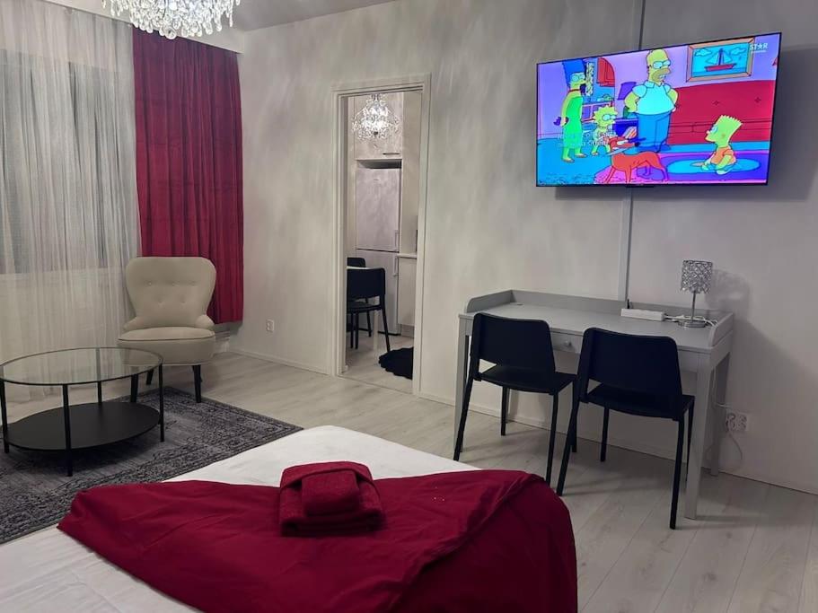 诺基亚BlueSolarPearl R - Vaihtoehto majoittumiselle的一间卧室配有一张床、一张桌子和一台电视。
