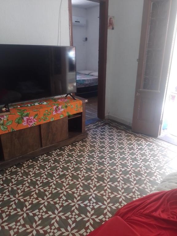 奥林达Casa Completa的客厅配有平面电视和电视架