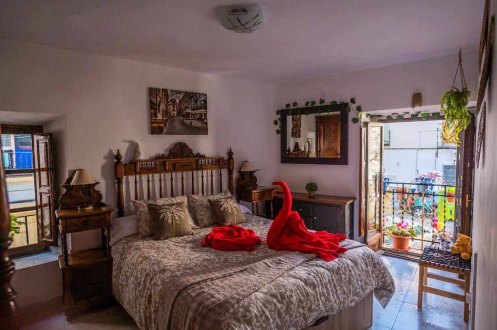 格拉纳达Casa Asia的一间卧室配有一张红色浴袍的床