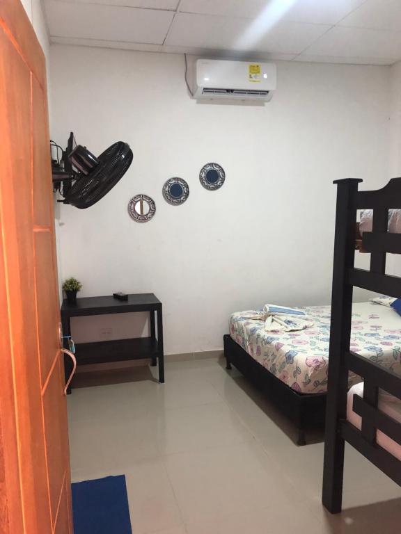 科韦尼亚斯Mónaco habitaciones的一间卧室配有一张床和一个床头柜,以及一张床和一张床,拥有一张床铺。