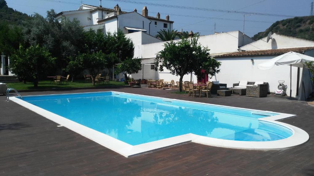 罗萨诺Agriturismo Malena的房屋前的游泳池