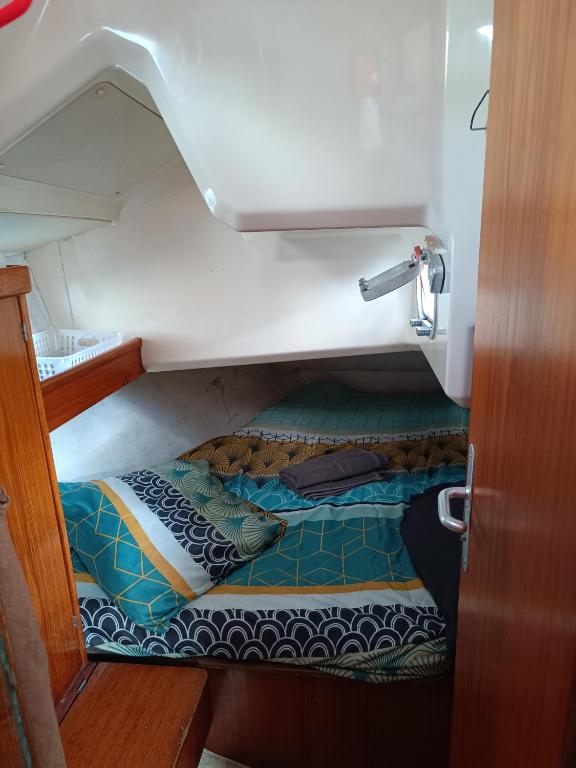 勒马兰cabine sur bateau à quai的小房间,船上有一张床