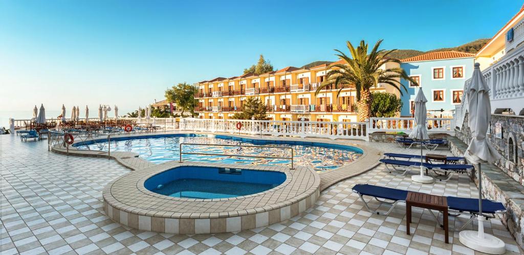 斯科派洛斯阿伊奥罗斯酒店的一个带桌椅的度假村游泳池