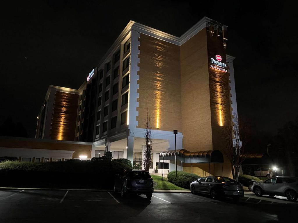 洛克维尔Best Western Premier Rockville Hotel & Suites的夜间在停车场停车的酒店