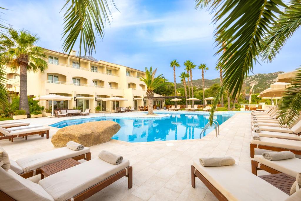 卡尔维Hotel Corsica & Spa Serena的度假酒店的游泳池配有躺椅