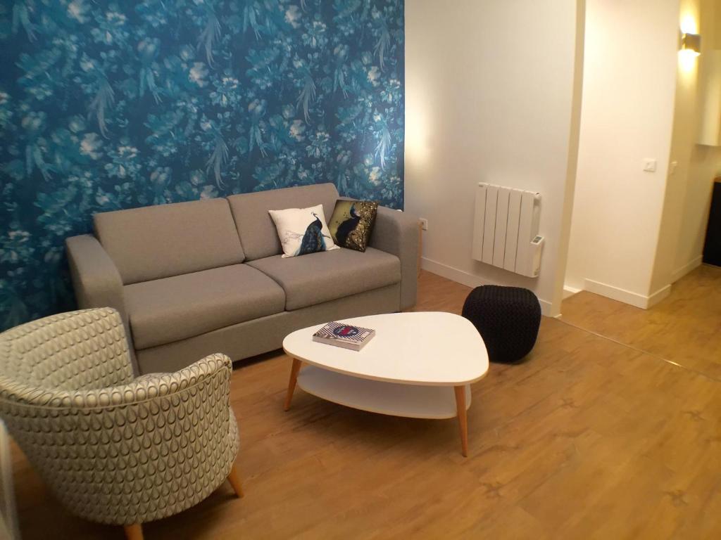 巴黎蓝色之家公寓的客厅配有沙发和桌椅