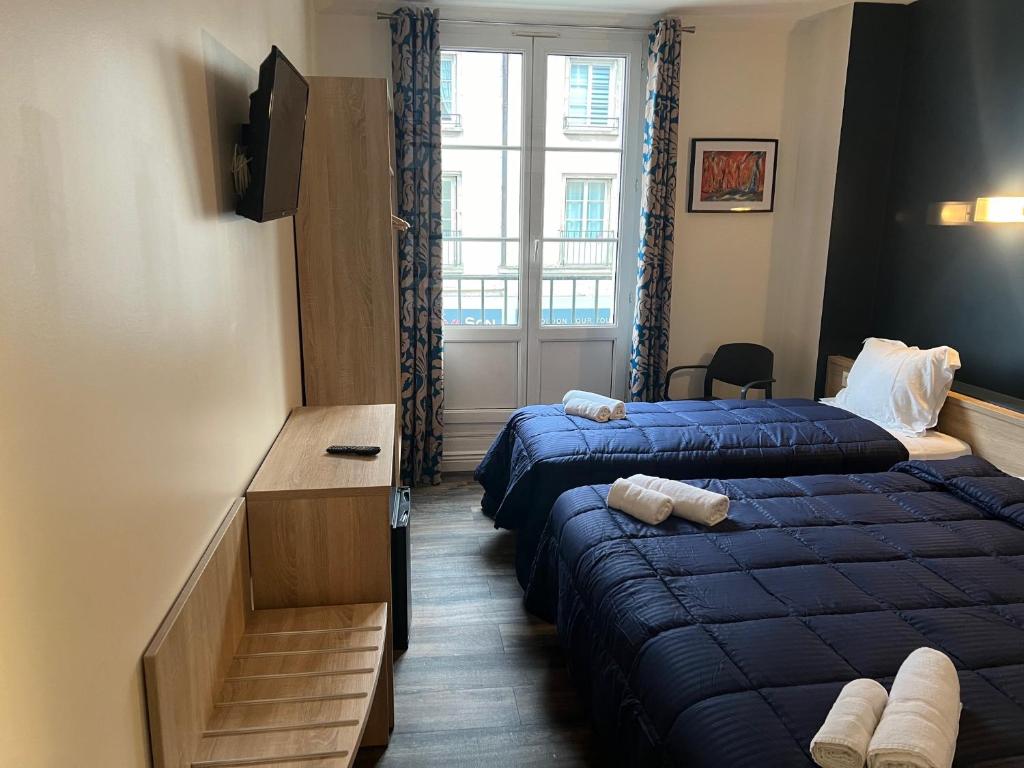 贡比涅Armor Hotel的酒店客房设有两张床和窗户。