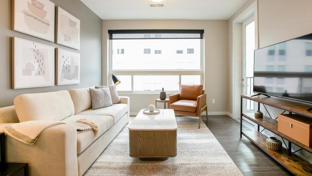 纽波特Landing Modern Apartment with Amazing Amenities (ID7744X77)的带沙发和电视的客厅