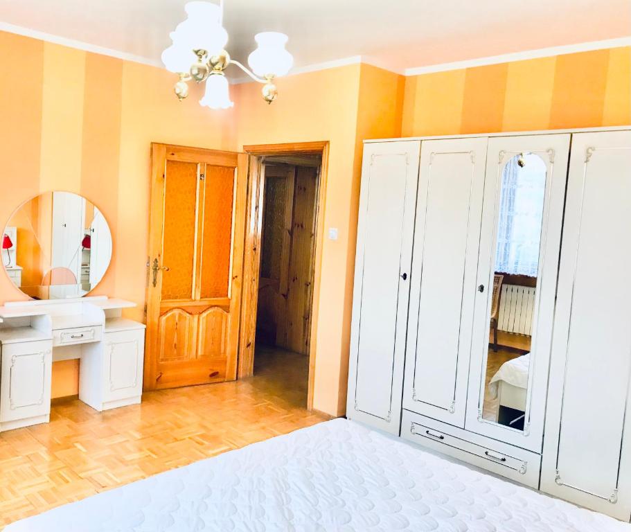 波兹南Noclegi Room Odlot Ławica 24h的一间带白色橱柜和镜子的浴室