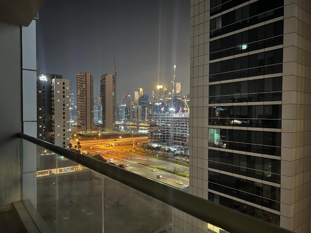 迪拜Oval Tower Business Bay的建筑在晚上可欣赏到城市美景