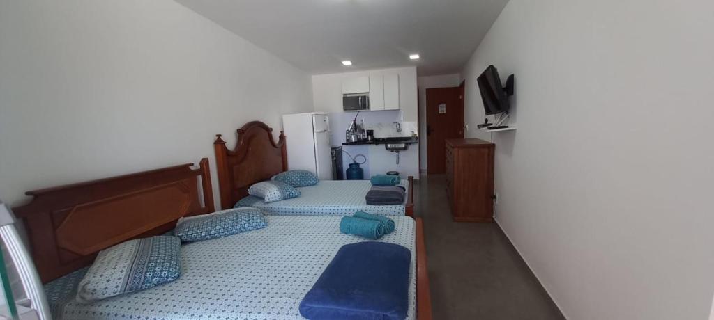 阿布拉奥Residencial 101 Ilha Grande的带3张床和蓝色枕头的客房
