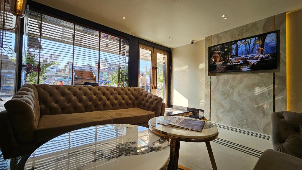 戈勒克布尔Ashoka Hotel的客厅配有沙发和桌子