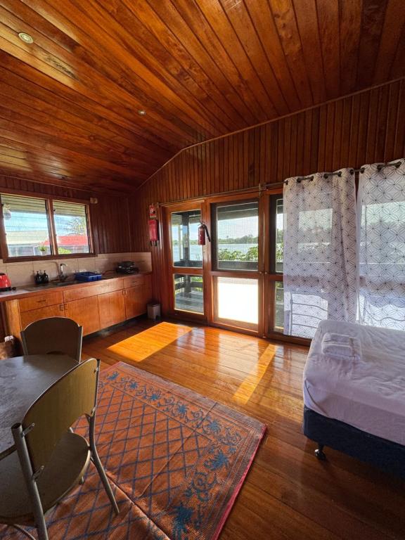 太平洋港Sunset View-Villa的卧室配有一张床和一张桌子及椅子