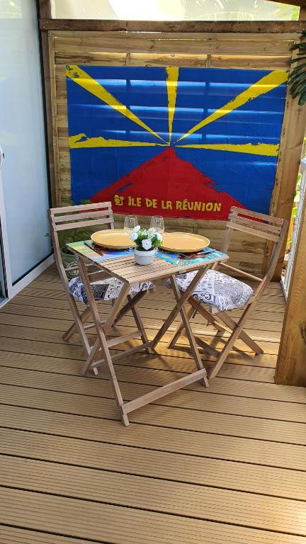 圣贝努瓦Les Clairs Matins的甲板上的野餐桌和两把椅子